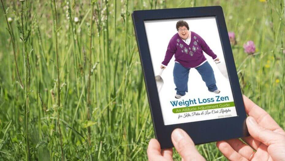 Find Your Weight Loss Zen Weight Loss Zen eBook displayed on an e-reader in a grassy field with wildflowers — digital low carb mindset guide for peaceful reading anywhere.